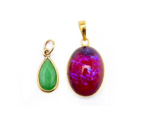 A CABOCHON GEM PENDANT AND A JADE PENDANT
Both in yellow metal settings
Largest measures 2.3cm long
Condition: Minor signs of