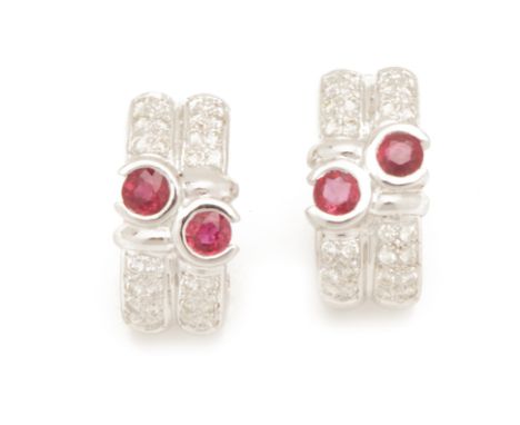 A PAIR OF RUBY AND DIAMOND EAR CLIPS
Set in 18k white gold, the round cut rubies, within multiple rows of pave set diamonds
1