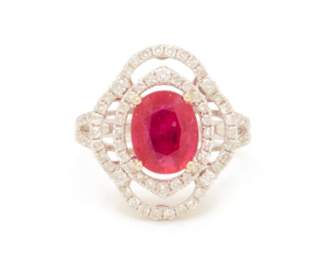 A RUBY AND DIAMOND RING
Set in 18k white gold, the central oval cut ruby, within two surrounds of round brilliant cut diamond