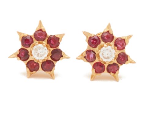 A PAIR OF RUBY AND DIAMOND FLOWERHEAD CLUSTER EARRINGS
Set in 18k yellow gold, the central round brilliant cut diamond, withi