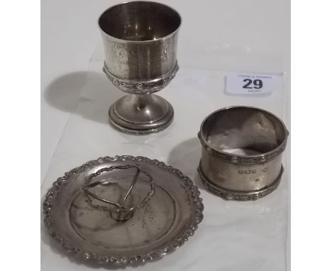 Arts and crafts style silver eggcup and napkin ring, with banded decoration of a stylised dragon between bosses, maker Adie B