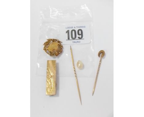 A little gold including a horse shoe stick pin, stick pin with synthetic pearl, tie clip and a wreath brooch