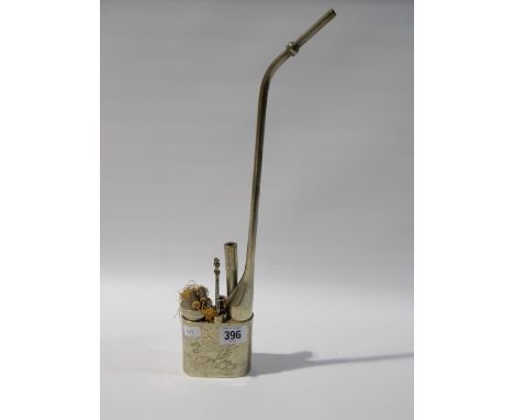 Chinese white metal opium pipe, of typical form with two implements, the sides decorated with a pair of figures within a gard