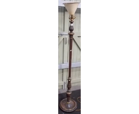 Walnut foliate carved, turned and fluted standard lamp with areas of gilding, upon a circular base, height overall 70'.
