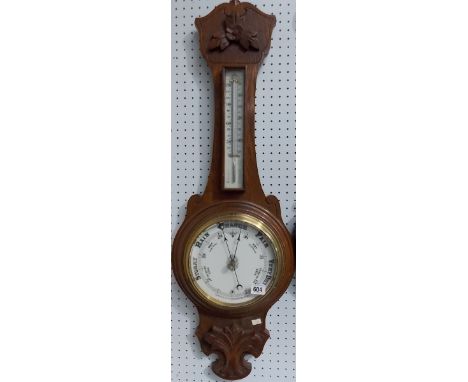 Oak banjo aneroid barometer thermometer within foliate carved case, height 35'.