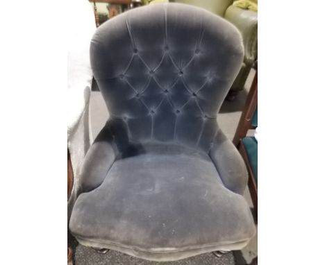 Victorian button back upholstered nursing chair with mahogany turned legs and brass caps and castors.