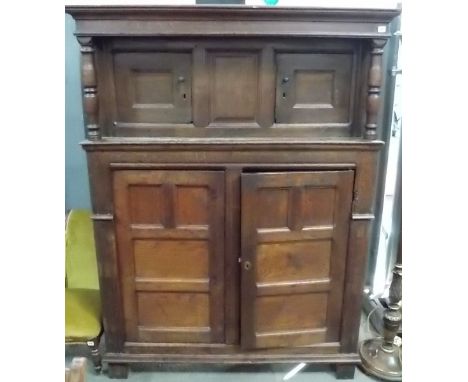 17th Century oak Court cupboard, of panelled construction, the moulded top over a central fielded panel flanked by two cupboa