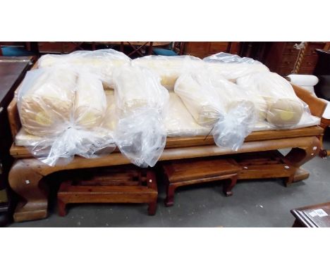 Oriental hardwood day/opium bed of large proportions, with cream and gilt thread silk embroidered cushions, the raised back o