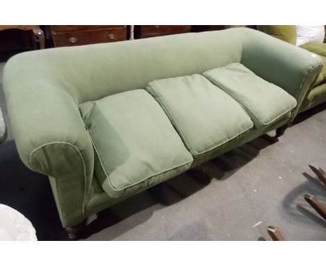 Victorian Chesterfield sofa, green upholstered and on turned legs with ceramic castors, width 74'.