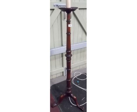 Mahogany turned standard lamp, upon three outswept paw legs, height overall 57'.
