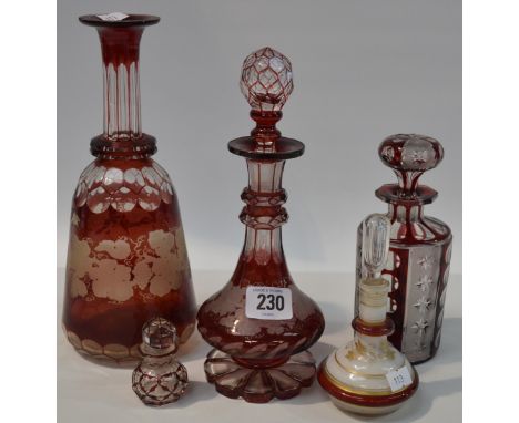 Victorian ruby overlay glasswares including wheel engraved and facet cut decanter and stopper, another decanter and stopper, 