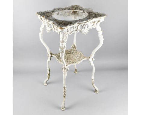 A Victorian White Painted Cast Iron Washstand with Ornate Moulded and Pierced Decoration with Scrolls, Maiden Mask Heads and 
