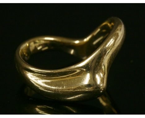 A gold wave ring by Tiffany,designed by Paloma Picasso, with a half wishbone section and graduated head.  Signed 'Tiffany &am