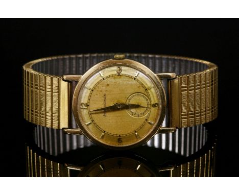 A gentlemen's 9ct gold Jaeger-LeCoultre mechanical watch, c.1960,on a later expanding bracelet.  A circular case, 30mm diamet