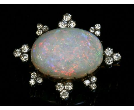 A Victorian opal and diamond brooch,with an oval cabochon opal, claw set to the centre.  A border of alternating trefoil clus