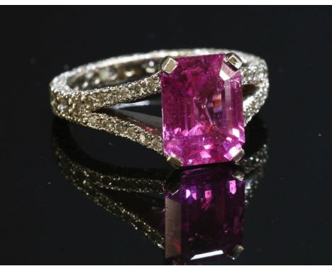 A platinum, single stone, pink sapphire and diamond ring,with an emerald cut pink sapphire, estimated as approximately 3.48ct