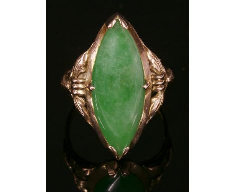 An Asian single stone jade ring,with a marquise-shaped cabochon jade, claw set at the points and the shoulders, to leaf shoul