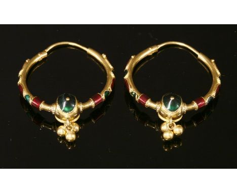 A pair of cased Indian, high carat gold, enamel, hollow hoop earrings,decorated with red and green enamel twisted wire circle