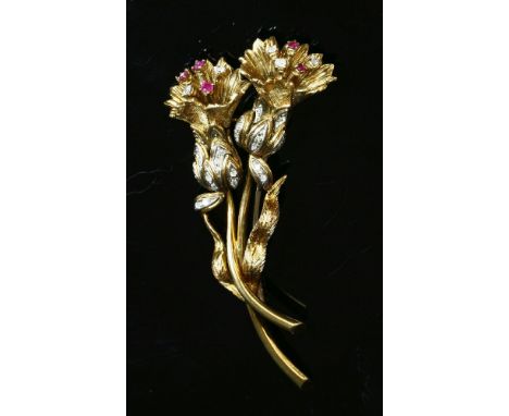 A Continental ruby and diamond gold spray brooch, c.1950,with Florentine textured petals and brilliant cut diamonds and circu