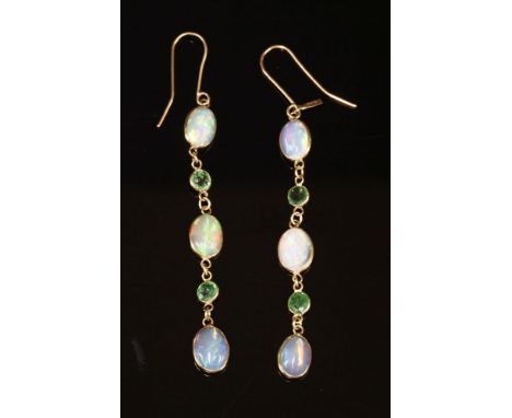 A pair of opal and chrome diopside gold earrings, with oval cabochon moonstones, spectacle set between circular mixed cut dio