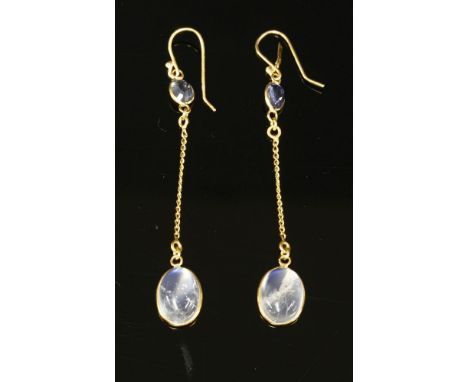 A pair of sapphire and moonstone gold drop earrings,with an oval mixed cut sapphire, spectacle set to the top.  Filed curb ch