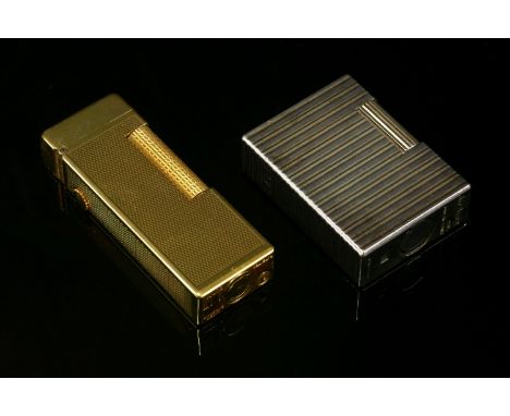 A cased Dunhill gold-plated lighter, engine turned decoration with plain polished lid, with paperwork, anda cased S T Dupont 