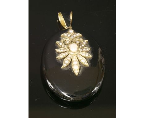 A Victorian onyx, split pearl and enamel memorial locket,with a gold palmette, grain set with graduated split pearls, applied