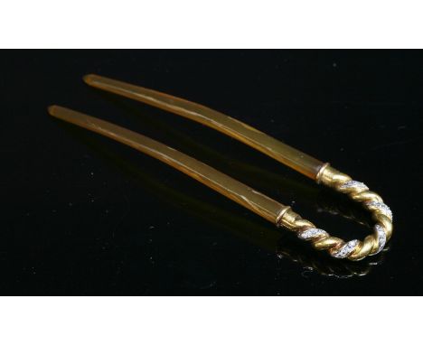 An Edwardian gold and diamond set hairpin or fourche,with a twisted rope arched top.  Sets of rose cut diamonds, grain set to