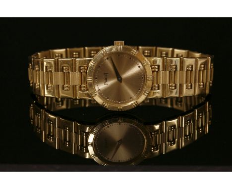A ladies 18ct gold Piaget 'Dancer' quartz bracelet watch,with a circular champagne dial, raised gold dot batons and gold swor