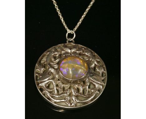 A Chinese silver and opal pendant, of circular form, with a central cabochon opal, rub set to the centre.  A relief pierced s