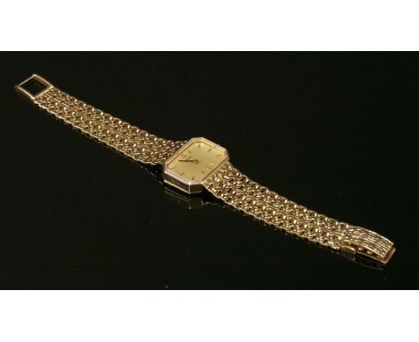 A ladies' 9ct gold Omega mechanical bracelet watch,with a rectangular cut corner landscape case.  A champagne dial with raise