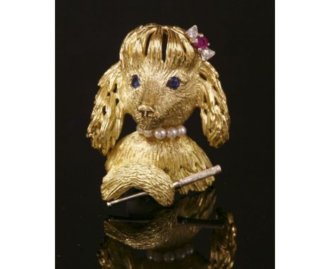 A Continental gold, sapphire, ruby and cultured pearl poodle brooch, c.1950,the novelty poodle with sapphire set eyes, a ruby