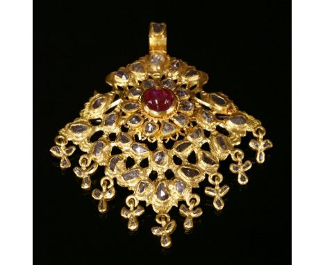 An Indian high carat gold, ruby and diamond pendant,with a later brooch fitting, with a ruby and diamond cluster to the centr