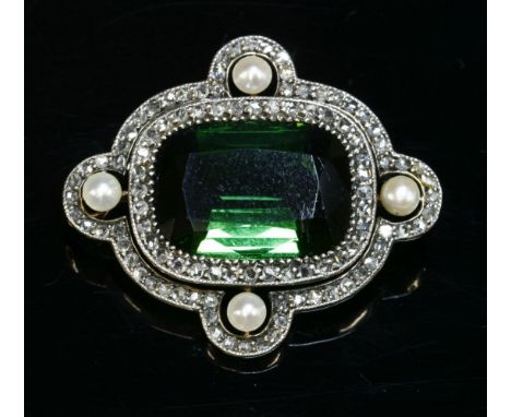 A cased tourmaline, diamond and pearl brooch/pendant, c.1905,with a cushion cut tourmaline claw set to the centre.  A cushion