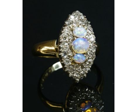 A late Victorian opal and diamond marquise-shaped cluster ring,with a replacement shank.  Three graduated oval cabochon opals