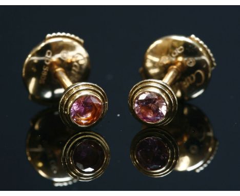 A pair of 18ct gold, Cartier, single stone, pink sapphire stud earrings,circular mixed cut pink sapphires, rub set to a stepp
