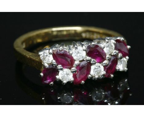 An 18ct gold, ruby and diamond two row ring,with alternating marquise cut rubies and brilliant cut diamonds, claw set to a wh