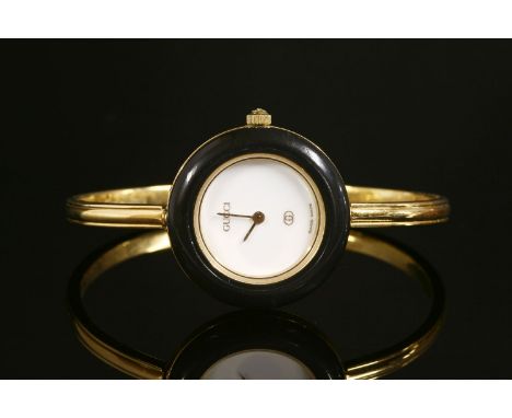 A ladies' gold-plated Gucci quartz bangle watch, 1100-L, with a complete set of interchangeable bezels, a circular white dial