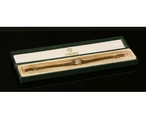 A ladies' 9ct gold Rolex precision mechanical bracelet watch, c.1950,with a circular case, 14mm diameter.  Silvered dial with