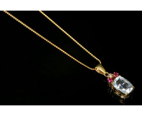 A gold, aquamarine, diamond and ruby pendant,with a cushion-shaped mixed cut aquamarine, four claw set at three corners in a 