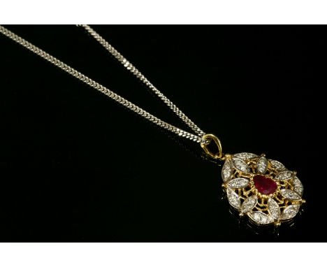 An 18ct gold, ruby and diamond cluster pendant,on a 9ct gold curb chain.  A pear-shaped mixed cut ruby, rub set to a notched 