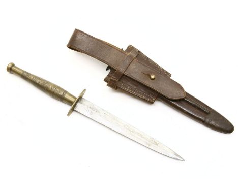 An Indian&nbsp;Fairbairn-Sykes&nbsp; WWII fighting knife, with etched brass handle and stiletto type blade, with original sca