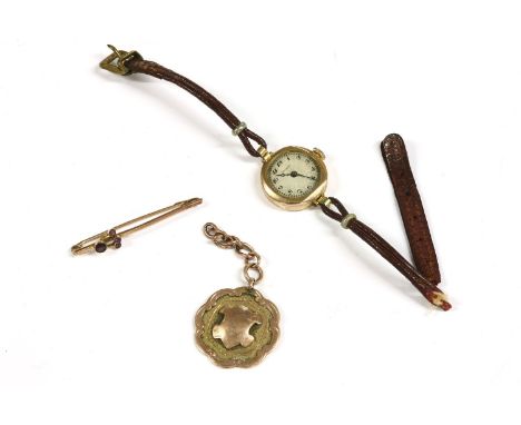 A 9ct gold medallion with vacant cartouche, 6.84g, a ladies 9ct gold Buren mechanical strap watch, 12.36g, a 9ct gold amethys