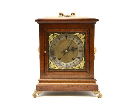 An Edwardian mahogany eight day bracket clock, the brass dial with silvered chapter ring and mask spandrels fitted gong strik