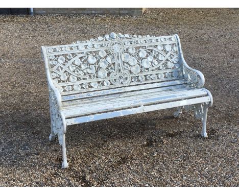 A Victorian design garden bench, the pierced foliage decorated back above slated seat, 130cm wide, 65cm deep, 82cm high
