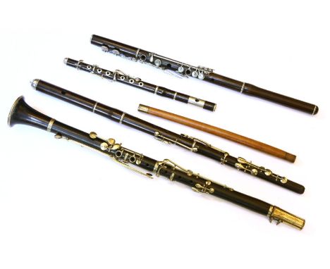 A collection of 19th Century woodwind musical instruments, to include a nickel mounted rosewood clarinet, a nickel mounted ro