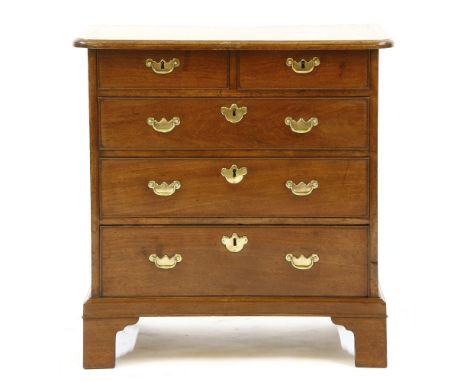 A George III mahogany chest of drawers of small proportions, with two short over three long drawers, with brass drop handles,