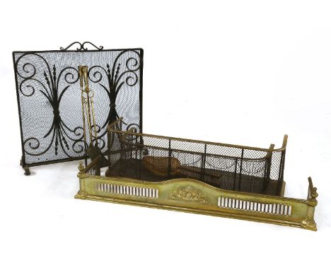 An Art Nouveau brass fender, a wrought iron spark guard and fire tools, and a pair of bellows