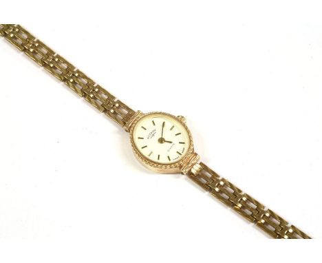 A ladies 9ct gold Rotary quartz bracelet watch, with white dial, baton numerals and a three row diamond cut integral 9ct gold