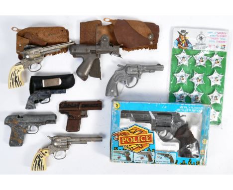 A collection of original vintage toy cap guns along with a carded set of Gohner Sheriff Cowboy badges. Comprises a boxed Gonh